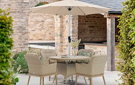 Bramblecrest Monterey 120cm Round Dining Table & 4 Deluxe Vogue Armchairs, Parasol & Base - Sandstone-X25MVS07 1