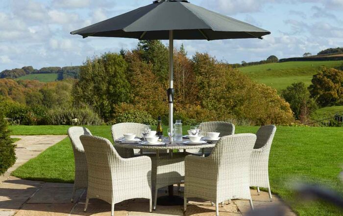 Bramblecrest Tetbury Tree Free Six Seat Round Dining Set with Parasol - Cloud Bramblecrest Tetbury Tree Free Six Seat Round Dining Set with Parasol - Cloud